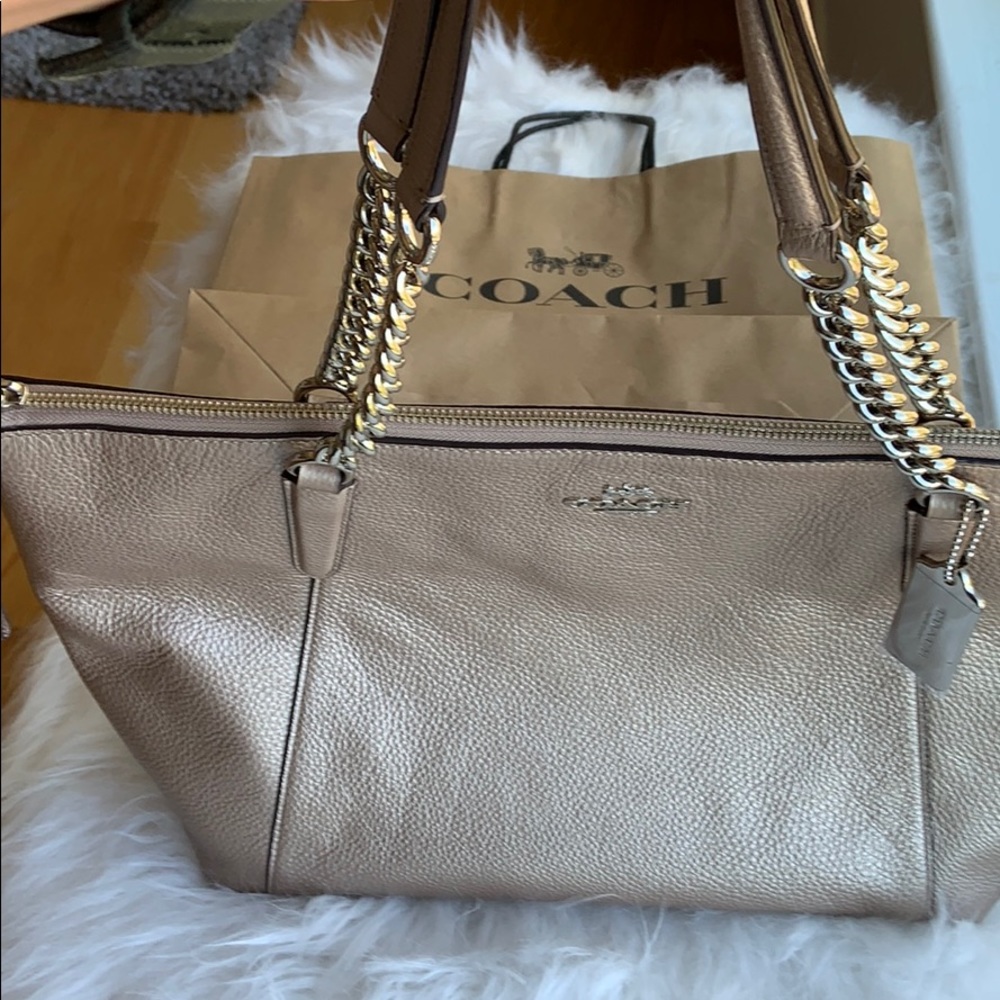 Gently used Coach rose gold/platinum leather purse